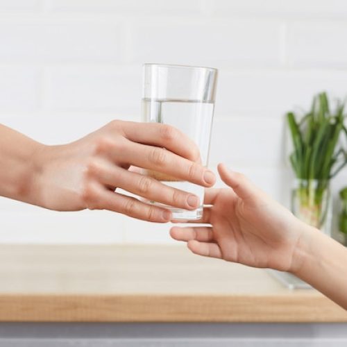 woman-s-hand-gives-glass-purified-water-her-child-concept-purification-water_179369-7